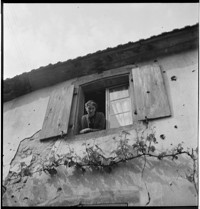[Ammerschwihr: woman in upstairs window of home riddled by bullets or shrapnel]