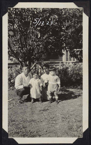 Photograph of man and woman posing with children