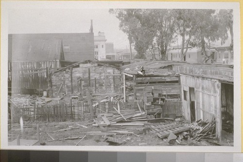 Shacks at 568 So. Central, adjoining S. P. [Southern Pacific] depot grounds, S. P. depot, in background