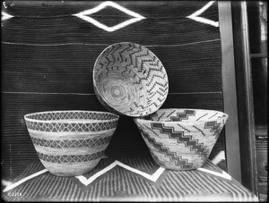 Three Walapai Indian basket on display, ca.1900
