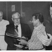 Tom Kane. Caption: Bee Scribe Honored. Sacramento Sportswriter Tom Kane, center, receives an engraved plaque from Cappy Harada in recognition for his 25 years of service to baseball