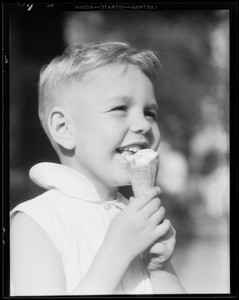 Boy eating ice cream cone, Southern California, 1932