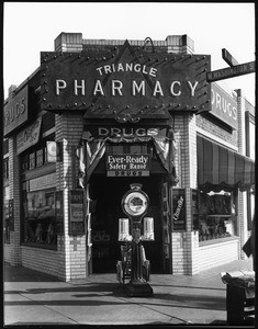 Exterior view of the Triangle Pharmacy on the corner of Washington Street and Hoover Street, ca.1920-1960