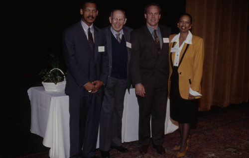 Peter Drucker standing with three individuals