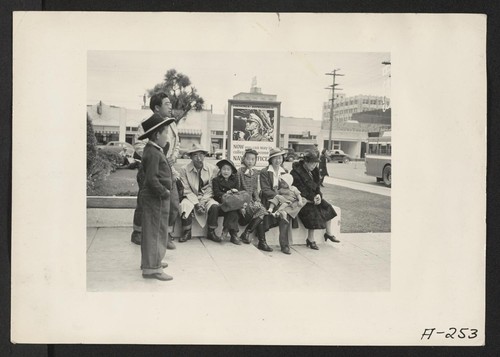 Salinas, Calif.--Evacuees of Japanese ancestry waiting for the bus which will take them to the Salinas Assembly Center. They will later be transferred to a War Relocation Authority center to spend the duration. Photographer: Albers, Clem Salinas, California