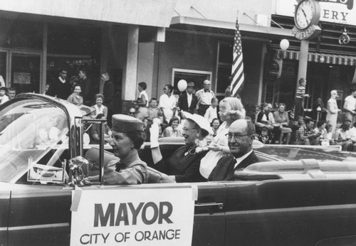 May Day Parade, City of Orange Mayor Rex Parks and family riding in convertible, Orange, California, 1950