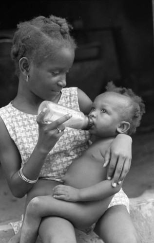 Girl feeding a baby, San Basilio de Palenque, 1976