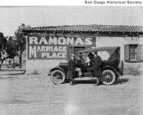 Two men and an automobile parked in front of Ramona's Marriage Place in Old Town