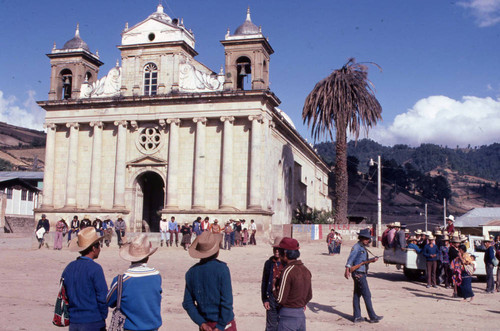 People standing and sitting outside the church, Nahualá, 1982