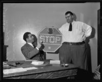 Judge Joseph Marchetti and Henry “Happy Hi” Rohwer holding the stop sign to be used for Henry’s punishment for a traffic violation, Los Angeles, 1935