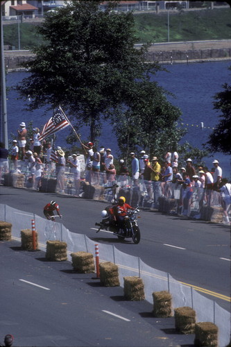 [1984 Olympics Men's Cycling Road Race showing cyclist, photographer, and Lake Mission Viejo slide]