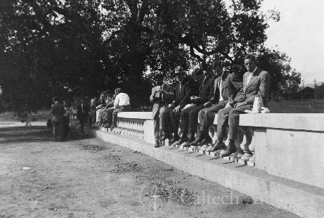 Throop College students sitting on a wall