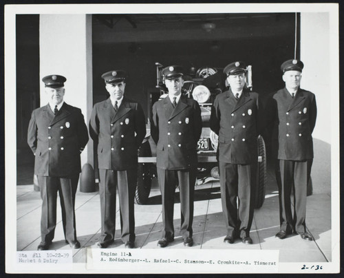 Firefighters in dress uniforms stand in front of open apparatus bay at Station No. 11, Market Street & Dairy Avenue