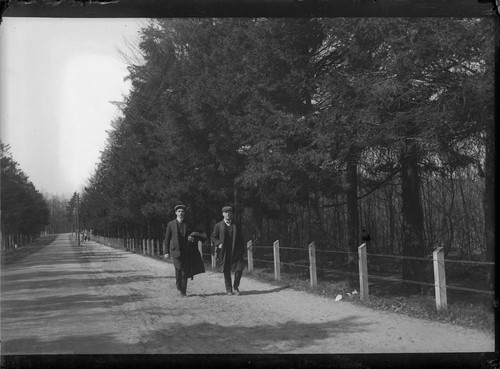 [Two men walking along road in countryside.] [negative]