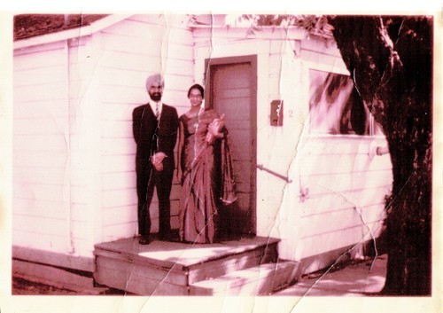 Narinder and Savitri Randhawa in front of a house