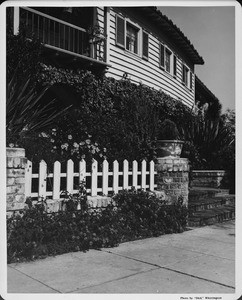 Residential home in 1948, picket fence, sidewalk, landscaping, flowers