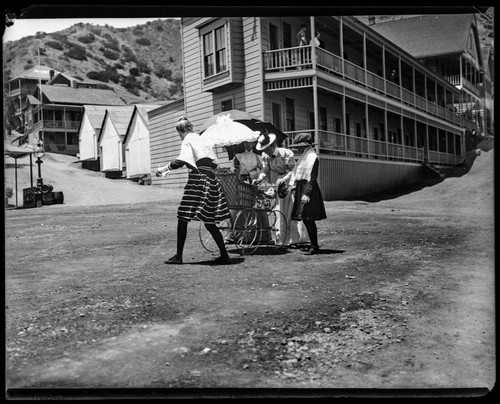 Group of people with baby carriage in the street, Catalina Island