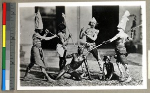 Six Hindu men worshipping the devil by dancing, Vārānasi , India, ca. 1920