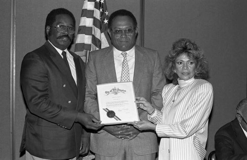 Black Enterprise Magazine luncheon participant receiving a commendation, Los Angeles, 1987