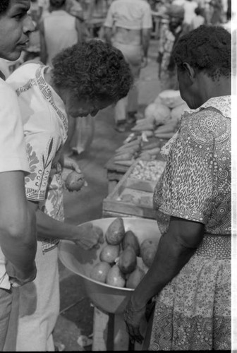 Woman selling fruits at market, Cartagena Province, 1975