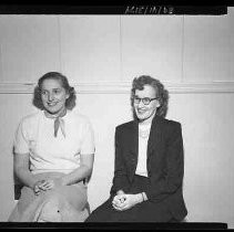 Two women posed seated