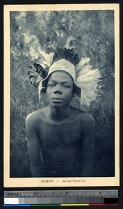 Young man wearing a feathered headdress, Gabon, ca.1900-1930