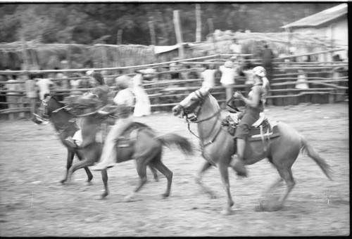 Three women ride horses in a bullring, San Basilio de Palenque, 1975