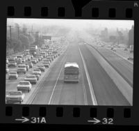 Rapid Transit District bus traveling in El Monte-Los Angeles bus lane, passing rush hour traffic on San Bernardino Freeway, 1973