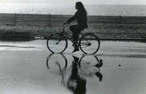 Pepperdine student riding a bike near the beach in Malibu, 1978