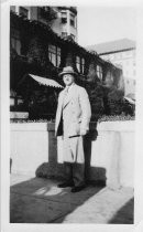 Man standing outside building 1926
