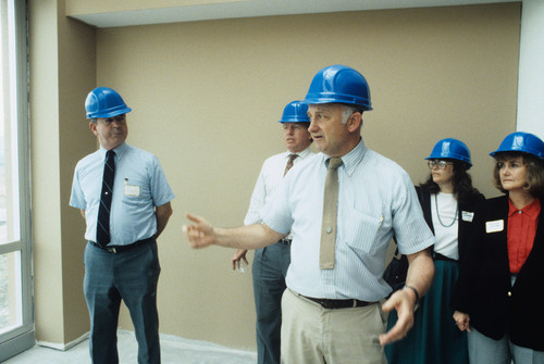 People on a tour in blue hard hats