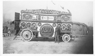 Circus - Calif. - Stockton: Unidentified man standing in front of Cole Bros. circus wagon Asia
