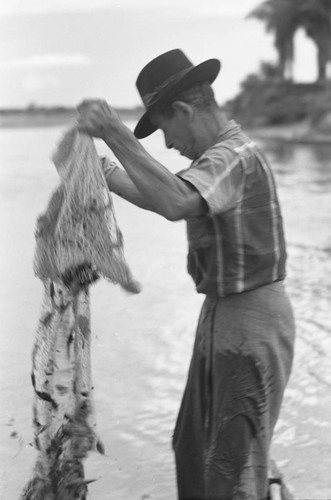 Fisherman holding a net, La Chamba, Colombia, 1975