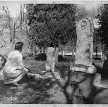A visitor examines one of the old tombstones in the Thomspon's Flat Cemetery near Oroville, Butte County