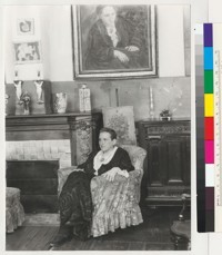 [Gertrude Stein seated beneath her portrait by Picasso.]