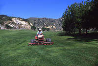1978 - Gardener Mowing Lawn at DeBell Golf Course
