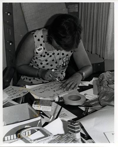 Woman writing a sign