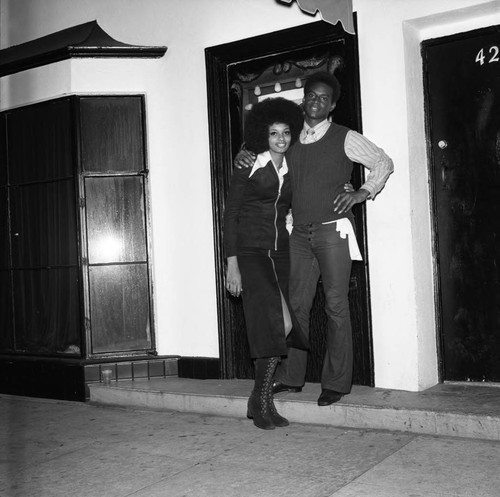 Man and woman posing in front of Maverick's Flat, Los Angeles, 1971