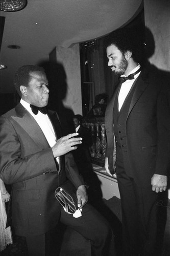 Sidney Poitier talking with James Ingram at a Neighbors of Watts benefit, Los Angeles, 1982