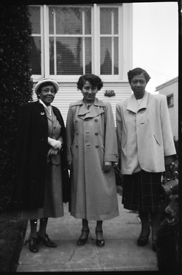 Faricita Wyatt (right) and two women standing on walkway in front of house