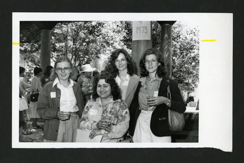 Scrips alumnae from the class of 1973 standing together in the Margaret Fowler Garden, Scripps College