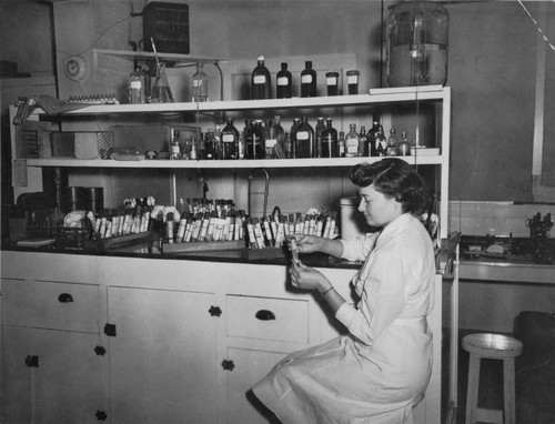 Blanche working in the lab at San Bernardino County Hospital, [graphic]