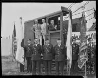 J.B. Irsfeld, Henry B.R. Briggs, and Will Hays in steam shovel for Hollywood post office ground breaking, with color guard, Hollywood, 1935