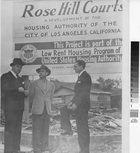 Photograph of Housing Authority of the City of Los Angeles officials standing in front of sign advertising Rose Hill Courts