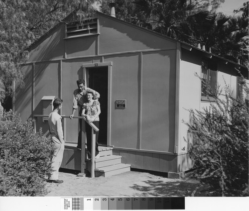 Photograph of three people outside a unit at Keppler Grove
