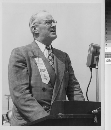 Photograph of Langdon Post at the podium during the dedication ceremony of Rodger Young Village