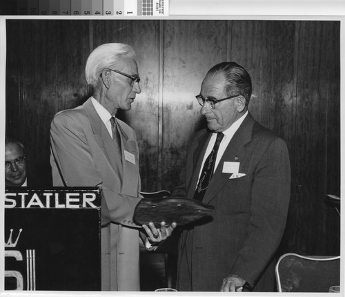 Mr. Leo Vie presenting Mr. Nicola Giulii with plaque at award luncheon