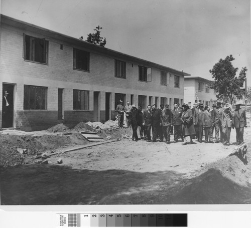 Photograph of group of people touring Ramona Gardens public housing site