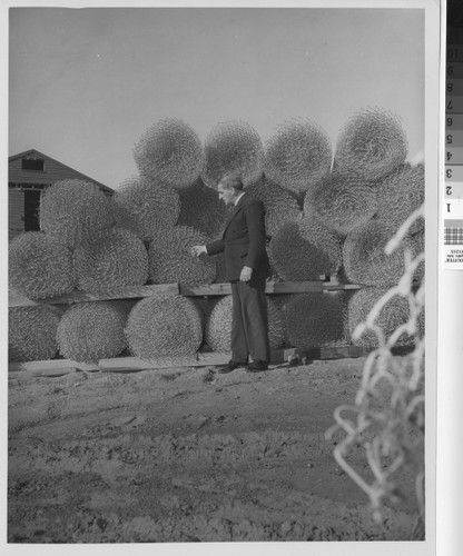 Photograph of man inspecting building materials for Basilone Homes