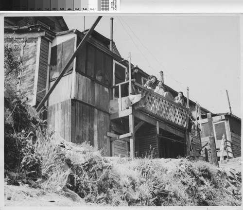 Photograph of four women on a balcony